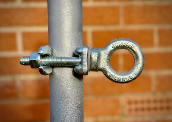 The Jordan Clamp against a red brick background.